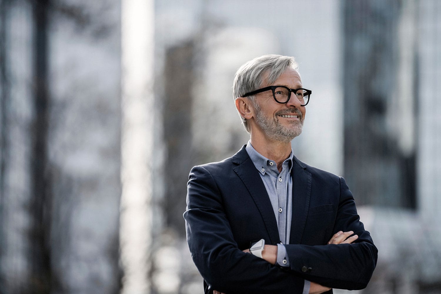 Professional male attorney in formal suit outdoors, smiling confidently, representing expert legal services in business law and estate planning for clients seeking trustworthy legal advice.